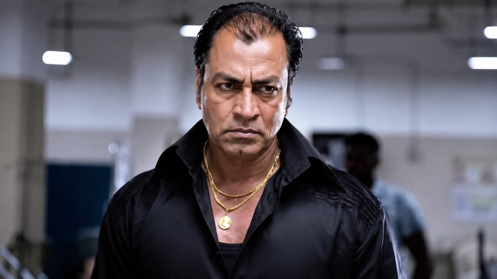 Actor Pradeep Rawat in a dark suit posing gracefully, known for his roles in Ghajini and Lagaan.